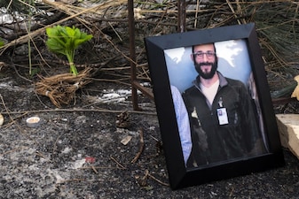 A photograph of 37-year-old Alex Pretti can be seen at a makeshift memorial in the area where he was shot dead by federal immigration agents earlier in the day in Minneapolis, Minnesota, on January 24, 2026. Federal immigration agents shot dead a man in Minneapolis on Saturday, in the second fatal shooting of a civilian during the Trump administration's unprecedented operation in the city, sparking fresh protests and outrage from state officials. The death came less than three weeks after US citizen Renee Good was shot and killed by an ICE officer. (Photo by ROBERTO SCHMIDT / AFP)