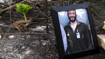 A photograph of 37-year-old Alex Pretti can be seen at a makeshift memorial in the area where he was shot dead by federal immigration agents earlier in the day in Minneapolis, Minnesota, on January 24, 2026. Federal immigration agents shot dead a man in Minneapolis on Saturday, in the second fatal shooting of a civilian during the Trump administration's unprecedented operation in the city, sparking fresh protests and outrage from state officials. The death came less than three weeks after US citizen Renee Good was shot and killed by an ICE officer. (Photo by ROBERTO SCHMIDT / AFP)