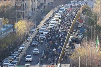 Protesters march on a bridge in Tehran, Iran. AP