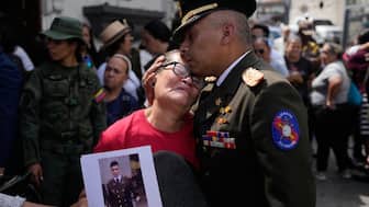 Members of the military place the coffin of Venezuelan soldier Cesar Garcia, killed in a U.S. raid that captured Venezuelan President Nicolas Maduro, into a hearse after his wake in Caracas, Venezuela, Wednesday, Jan. 7, 2026. AP