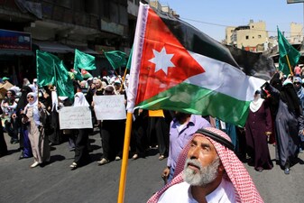 A Jordanian protester carries the national flag during a rally by the Muslim Brotherhood, in Amman, Jordan. File image/AP