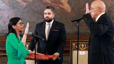 Venezuela's Vice President Delcy Rodriguez (left) takes an oath as interim president in front of National Assembly President Jorge Rodriguez (right) and Deputy Nicolas Maduro Guerra (centre) during a session of the National Assembly in Caracas on January 5, 2026. (Photo: Marcelo Garcia/Miraflores Press Office/AFP)