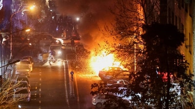 Cars burn in a street during a protest over the collapse of the currency's value in Tehran, Iran, on January 8, 2026. (Photo: Stringer/WANA via Reuters) 