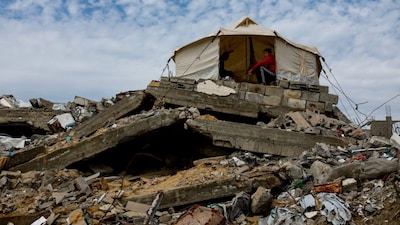 Palestinians gather in a tent that is placed on top of the rubble of buildings destroyed during the war in Jabalia, northern Gaza Strip, December 31, 2025. File Image/Reuters