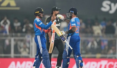 India's captain Suryakumar Yadav, right, greets India's Abhishek Sharma as he scores fifty run during the third T20 cricket match between India and New Zealand in Guwahati, India, Sunday, Jan. 25, 2026. (AP)