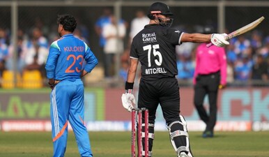 New Zealand's Daryl Mitchell, right, celebrates his fifty runs as India's Kuldeep Yadav looks on during the third One Day International cricket match between India and New Zealand in Indore, India, Sunday, Jan. 18, 2026. (AP)