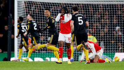 Manchester United players celebrate Matheus Cunha's 87th-minute equaliser in their Premier League meeting with leaders Arseanal at the Emirates Stadium. Reuters