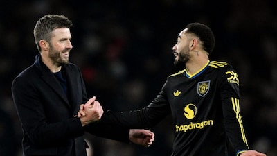 Michael Carrick celebrates with Matheus Cunha following Manchester United's 3-2 victory over Arsenal at the Emirates Stadium. Reuters