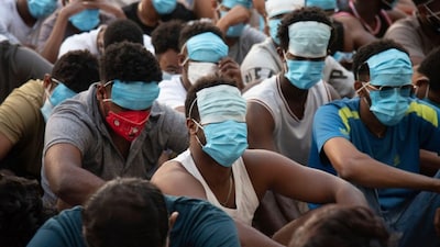 People from China, Vietnam and Ethiopia, believed to have been trafficked and forced to work in scam centres, sit with their faces masked while in detention after being released from the centres in Myawaddy district in eastern Myanmar, February 26, 2025. File Image/AP