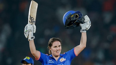 Mumbai Indians' Nat Sciver-Brunt celebrates after completing her century against Royal Challengers Bengaluru in Vadodara on Monday, 26 January. PTI