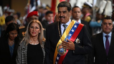 Venezuela's President Nicolas Maduro arrives with his wife Cilia Flores to deliver his annual speech to parliament in Caracas on January 15, 2025.- AFP