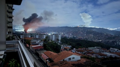 This grab taken on January 3, 2026, from UGC footage released by Jose Abreu in his X account @Jabreu89, shows smoke billowing over Caracas after a series of explosions part of a US military operation that led to the capture of Venezuelan President Nicolas Madruo.- AFP