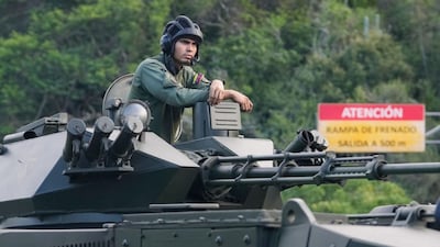 A soldier stands atop an armored vehicle driving toward Caracas, Venezuela, Sunday, Jan. 4, 2026. (AP Photo)