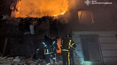 This handout photograph taken and released by the State Emergency Service of Ukraine on January 8, 2026, shows rescuers working to extinguish a fire in a heavily damaged residential building following a Russian missile attack in Kryvyi Rig, Dnipropetrovsk region.- AFP