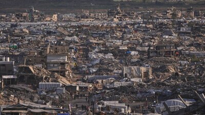 Makeshift tents shelter displaced Palestinians stand among buildings destroyed by Israeli air and ground operations in Gaza City Thursday, Jan. 15, 2026. (AP Photo/Jehad Alshrafi)

