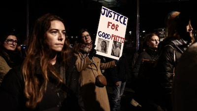 An anti-ICE protester holds a placard during a rally to demonstrate against US President Donald Trump's immigration policies at the old port of Marseille, southeastern France on January 28, 2026.-AFP