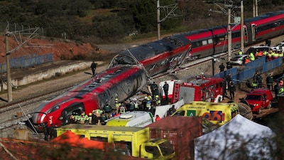 Members of the Spanish Civil Guard, along with other emergency personnel, work next to one of the trains involved in the accident, at the site of a deadly derailment of two high-speed trains near Adamuz, in Cordoba, Spain, on Monday. Reuters