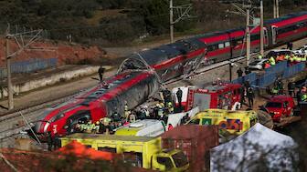 Members of the Spanish Civil Guard, along with other emergency personnel, work next to one of the trains involved in the accident, at the site of a deadly derailment of two high-speed trains near Adamuz, in Cordoba, Spain, on Monday. Reuters