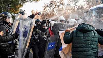 Turkish riot police officers use tear gas to disperse protesters during a demonstration against the attacks by the Syrian government forces in Diyarbalir, on January 19, 2026. (AFP)