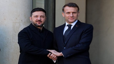 French President Emmanuel Macron shakes hands with Ukraine's President Volodymyr Zelenskyy as he arrives for a lunch meeting before a summit of the so-called 'Coalition of the Willing' at the Elysee Palace in Paris, France, on Tuesday. Reuters