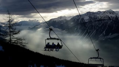Ski racers sit on the chairlift in the early morning before the first run of the men's Alpine Skiing World Cup Giant Slalom race in Crans-Montana February 26, 2012. Reuters