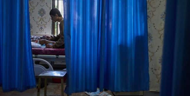 Mukesh Awasti, 22, who took part in September protests against corruption in Nepal and lost his leg after being shot by security forces, lies on a hospital bed during treatment in Kathmandu, Nepal, on Dec. 8, 2025.