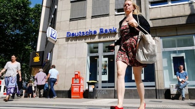 A woman walks in front of a branch of Germany's Deutsche Bank in Cologne, Germany, July 18, 2016. File Photo/Reuters