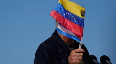 Cuban President Miguel Diaz-Canel waves Venezuelan and Cuban national flags during a rally in Havana, Saturday, Jan. 3, 2026, in solidarity after the U.S. captured President Nicolas Maduro and flew him out of Venezuela. Image Credit: AP