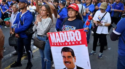 A demonstrator displays a sign with an image of U.S.-deposed Venezuelan President Nicolas Maduro during a march outside the National Assembly on the day Vice President Delcy Rodriguez was formally sworn in as Venezuela's interim president, as Maduro appeared in a New York court after the Trump administration removed him from power, in Caracas, Venezuela January 5, 2026. REUTERS.