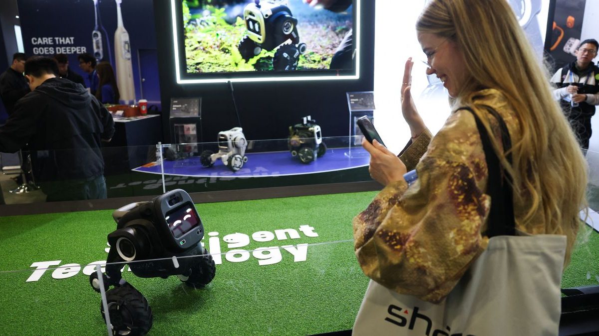 An attendee waves at the Sentigent Technology ROVAR X3 outdoor companion robot as it is demonstrated during the annual Consumer Electronics Show (CES). Image Credit: AFP An attendee waves at the Sentigent Technology ROVAR X3 outdoor companion robot as it is demonstrated during the annual Consumer Electronics Show (CES). Image Credit: AFP