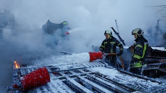 Firefighters extinguish semi-trucks damaged during Russian overnight drone and missile strikes, amid Russia's attack on Ukraine, in Kyiv, Ukraine, on January 24. (Reuters)
