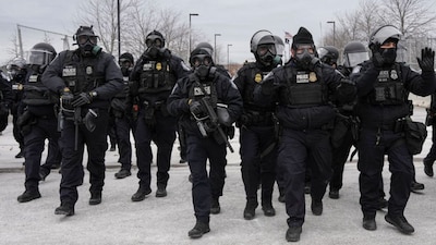 U.S. Customs and Border Protection (CBP) agents walk during a demonstration outside the Whipple Federal Building, more than a week after a U.S. Immigration and Customs Enforcement (ICE) agent fatally shot Renee Nicole Good on January 7, in Minneapolis, Minnesota, U.S., January 15, 2026. REUTERS/Tim Evans