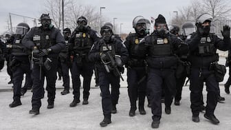 U.S. Customs and Border Protection (CBP) agents walk during a demonstration outside the Whipple Federal Building, more than a week after a U.S. Immigration and Customs Enforcement (ICE) agent fatally shot Renee Nicole Good on January 7, in Minneapolis, Minnesota, U.S., January 15, 2026. REUTERS/Tim Evans