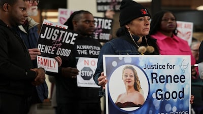 Attendees hold signs during a press conference, following the fatal shooting of Renee Nicole Good by a US Immigration and Customs Enforcement (ICE) agent, in Minneapolis, Minnesota. Reuters