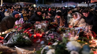 People lay flowers and light candles for the victims of the fire at the "Le Constellation" bar and lounge during New Year's celebration, in Crans-Montana, Switzerland. AP