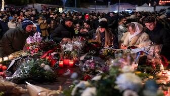 People lay flowers and light candles for the victims of the fire at the "Le Constellation" bar and lounge during New Year's celebration, in Crans-Montana, Switzerland. AP