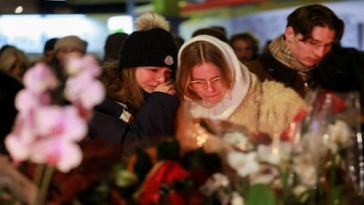 People weep outside the "Le Constellation" bar, after a fire and explosion during a New Year’s Eve party where several people died and others were injured, according to Swiss police, in the upscale ski resort of Crans-Montana in southwestern Switzerland. Reuters