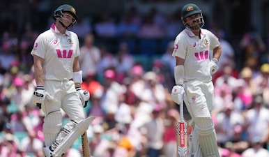 Australia's Travis Head, right, watches a third umpire video review to confirm his dismissal with teammate Steve Smith during play on day three of the fifth and final Ashes cricket test between England and Australia in Sydney, Tuesday, Jan. 6, 2026. AP