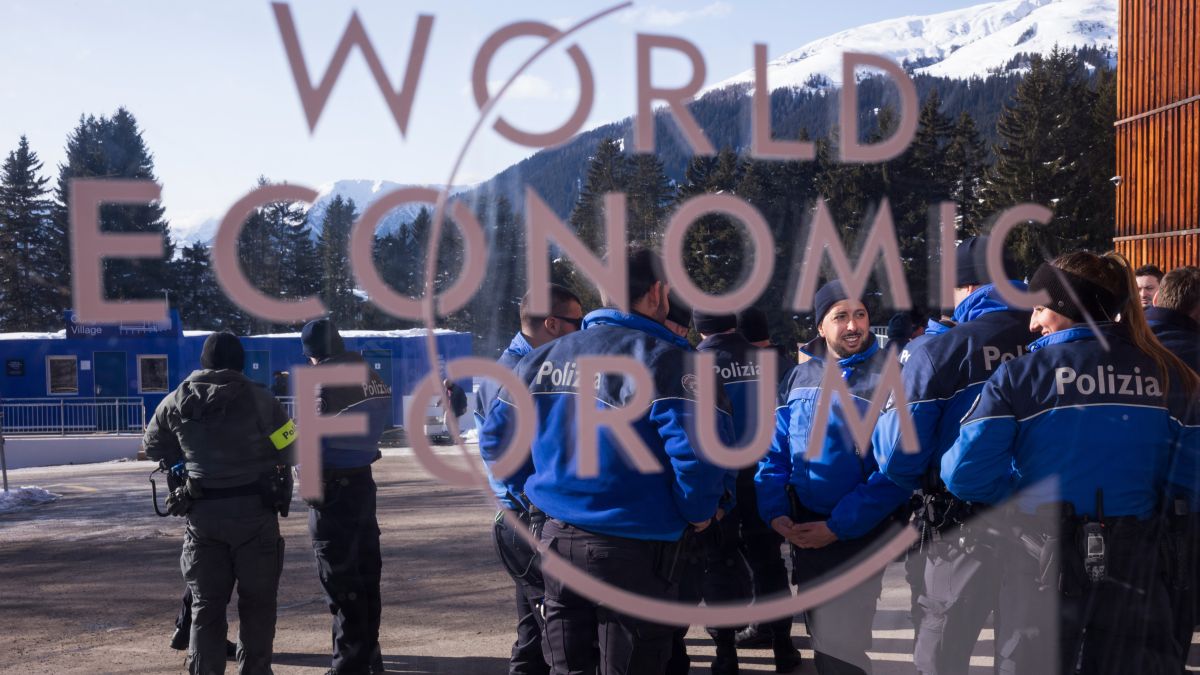Police officers stand behind a logo of the World Economy Forum in front of the Congress Center where the Annual Meeting Forum takes place in Davos, Switzerland, from Janauary 19 to January 23. AP Police officers stand behind a logo of the World Economy Forum in front of the Congress Center where the Annual Meeting Forum takes place in Davos, Switzerland, from Janauary 19 to January 23. AP
