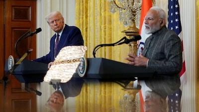US President Donald Trump and Indian Prime Minister Narendra Modi are pictured in a mirror as they attend a joint press conference at the White House in Washington, DC, US, February 13, 2025. File Photo/Reuters