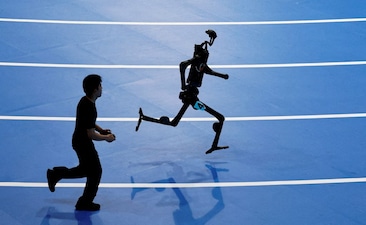 FILE PHOTO: A Unitree Robotics humanoid robot takes part in a 400m race at the inaugural World Humanoid Robot Games, at the National Speed Skating Oval in Beijing, China August 15, 2025. REUTERS/Tingshu Wang/File Photo