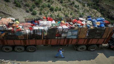A man walks past a truck loaded with belongings of Afghan nationals, as they head back to Afghanistan after Pakistan started to deport documented Afghan refugees, near Torkham border crossing between Pakistan and Afghanistan, on September 1, 2025. Reuters File

