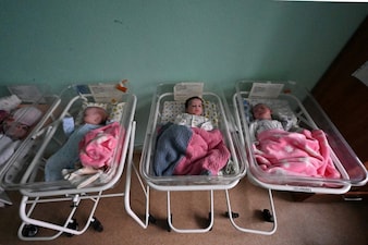 Newborn babies lie in their cots in a ward at the Kharkiv City Perinatal Center which did not stop working even after the Russian invasion of Ukraine, in Kharkiv on December 12, 2022. (Photo by SERGEY BOBOK / AFP)