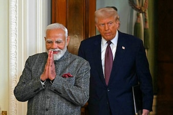 US President Donald Trump and Indian Prime Minister Narendra Modi arrive to hold a joint press conference in the East Room of the White House in Washington, DC, on February 13, 2025. (Photo by ANDREW CABALLERO-REYNOLDS / AFP)