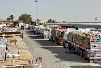 Trucks transporting humanitarian aid wait to enter through the Egyptian side of the Rafah border crossing with the Gaza Strip in northeastern Egypt on January 27, 2026, as the vital crossing to the Palestinian territory reopens. The Rafah crossing between Gaza and Egypt is the Palestinian territory's only gateway to the outside world that does not lead to Israel and is a key entry point for both people and goods. It had been closed since Israeli forces took control of it in May 2024, except for a limited reopening in early 2025, and other bids to reopen failed to materialise. (Photo by AFP)