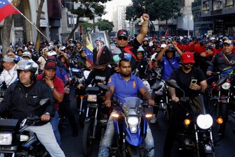 Government supporters ride motorcycles during a march one month after the ouster of Venezuelan President Nicolas Maduro and First Lady Cilia Flores in Caracas on February 3, 2026. Thousands of backers of Venezuela's former leader Nicolas Maduro, who was ousted in a deadly US military operation, marched in Caracas on February 3 to demand his freedom. (Photo by Pedro MATTEY / AFP)