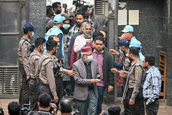 Voters enter a polling station during Bangladesh's general election in Dhaka on February 12, 2026. (Photo by MOHD RASFAN / AFP)