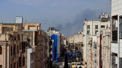 A plume of smoke rises following a reported explosion in Tehran on February 28, 2026. AFP