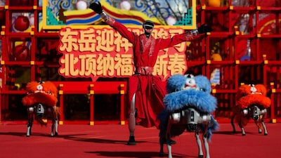 A humanoid robot performs a dance with robot dogs dressed in lion costumes on the first day of the Lunar New Year of the Horse, at the Niangniang Temple in Beijing, China, February 17, 2026. File Image/Reuters