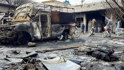 People walk amid damages at a police station following militant attacks in Quetta, Pakistan, on February 1, 2026. (Photo: Stringer/Stringer) 
